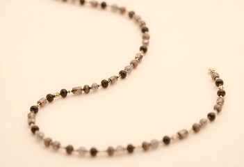 Obraz premium long beaded necklace on a white surface