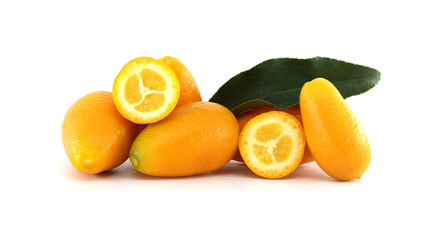 Fresh kumquats fruits and green leaves lying on white background