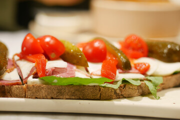 Delicious sandwich with fresh ingredients on a wooden table