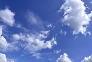 Billowing Clouds Dance Across Azure Canvas