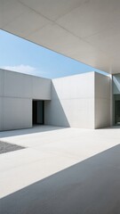 Modern minimalist architecture with clean lines and geometric shapes under a clear sky