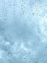 Raindrops on Window with Moody Cloudy Sky
