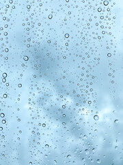 Raindrops on Window with Moody Cloudy Sky