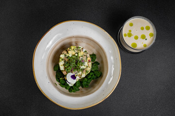 Cold summer soup okroshka. Light soup in a white bowl. 