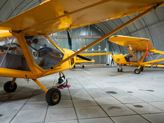 Yellow airplane glider in the hangar. 