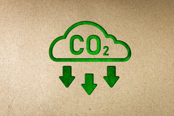 Green co2 reduction symbol on paper. Concept of carbon reduction campaign, zero greenhouse gas...