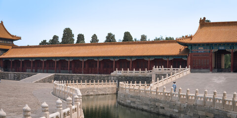 View of traditional Chinese architecture, stone bridge, and canal inside the Forbidden City with a...