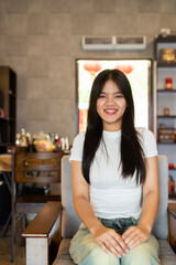 young woman sitting on a sofa in traditional Chinese cafe