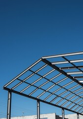 Fototapeta premium 青空広がる鉄骨構造 力強い骨組み 建築現場