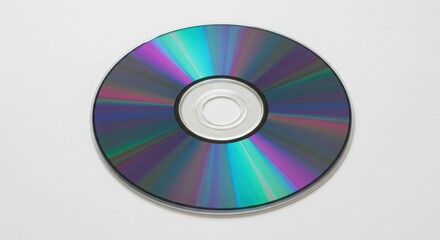 Shiny compact disc isolated on white background reflecting light in a colorful spectrum 