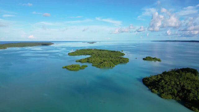 Maratua, Indonesia: Aerial drone footage of island inside the Maratua turquoise lagoon in the Derawan archipelago in Kalimantan in Indonesian Borneo. Shot with an upward motion 