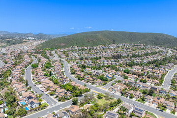 Aerial view of San Marcos neighborhood with houses and street during sunny day, South California, USA.