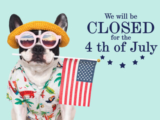 Signboard with the inscription We will be closed for the 4th of July. Cute puppy. Closeup, indoors....