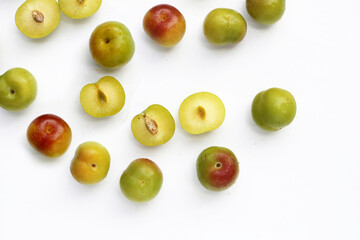 Fresh green plum fruit on white background.