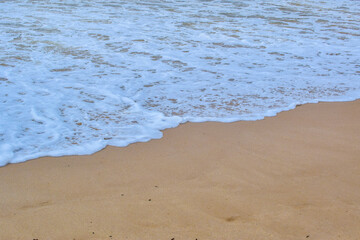bubbble white waves on the sand