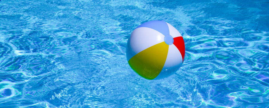 Summer day by the pool. Floating beach ball on pool water. Summer background. Inflatable toy. Summer vacation. Swimming pool with blue water. Paradise for leisure and rest concept. Summer poster.
