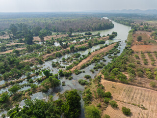 Lush green landscapes and winding rivers in Buon Don district, Dak Lak province, Vietnam during a sunny day
