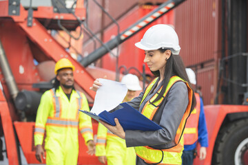 Female engineers managing cargo operations, Engineer and foreman dock worker checking containers...