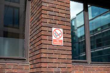 No Smoking Sign on Brick Wall in Urban Area