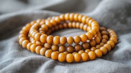 Close-up view of a wooden beaded bracelet on fabric.