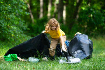 Child picking plastic trash for cleaning the nature. kid Clean up garbage outdoor. Ecology concept....