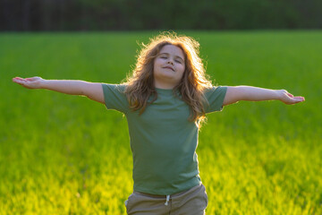 Child practicing calm meditation outdoors. Kid meditation in peaceful nature. Meditation moment with young child. Calm child. Meditate freely. Zen kids moment in green meadow. Nature child meditation.