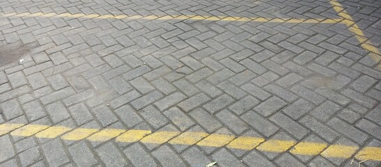 Gray Paving Stones with Yellow Parking Lot Lines