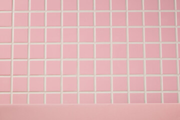 Soft pink mosaic tiles with square patterns fill the background. The flat pink shelf below makes a clean, calm surface for product staging in beauty, skincare, or personal care.