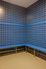 Fototapeta premium indoor swimming pool amenities: changing area perspective geometric pattern of tiles in a vacant changing area