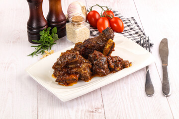 Prepared tasty beef ribs with sauce