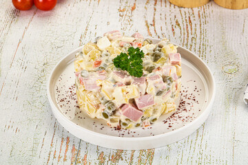 Russian traditional Olivier salad with sausages
