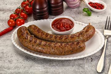 Grilled beef sausages with sauce