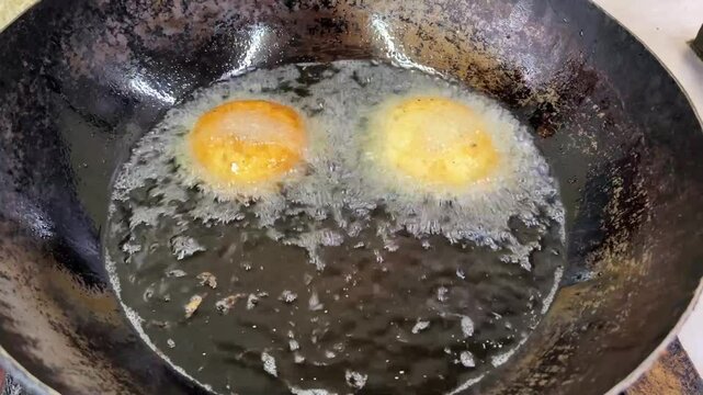 Masala Vada getting fried in hot oil in a restaurant in India