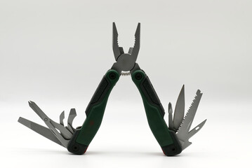 Multi tool with multiple functions and pliers isolated on white background.