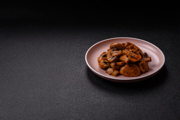 Food, baked mushrooms champignon slices with sauce and spices