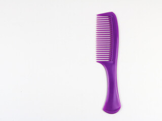 One purple plastic comb isolated - on white background