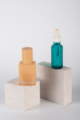 Blue serum bottle and cream sunscreen bottle with white background props