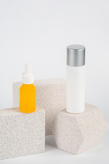 Plastic yellow tube for cream or lotion. Skin care or sunscreen cosmetic with stylish props on white background.