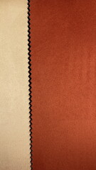 Fototapeta premium Textile Fabric Closeup Soft Velvety Surface Dual Color Contrast Zigzag Seam Beige Rust