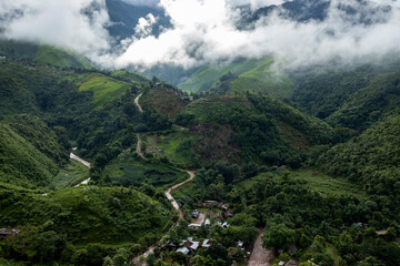 Landscape of Morning Mist with Mountain Layer. mountain ridge and clouds in rural jungle bush forest