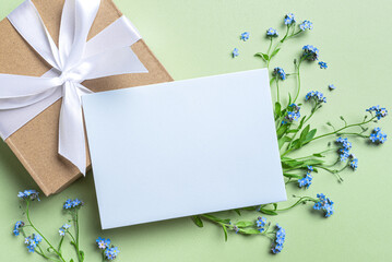 Greeting card and blue forget-me-not flowers