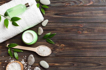 Coconut with jars of coconut oil and cosmetic cream on colored background. Top view. Free space for your text. Natural spa coconut cosmetics and organic treatment concept Coconut Spa composition