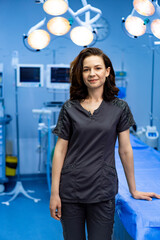 Surgeon ready in OR. A confident surgeon stands in a blue operating room, prepared for surgery,...