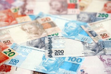 Brazilian reais banknotes. The current Brazil real money bills lies on table in big amount
