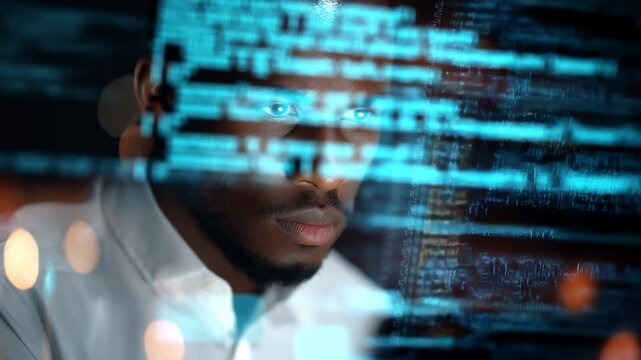 Focused African American Man Working Late, Immersed in Computer Programming in a Dark Office