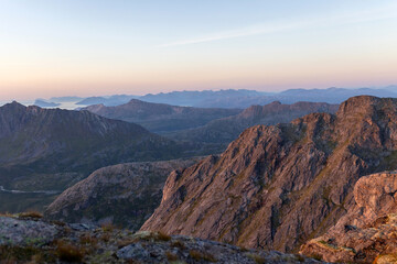 Children and adults, family with dog, hiking Grytetippen trail in Senja, Lofoten on a sunny hot summer day