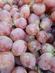 Close up of raw organic sweet red grapes background, wine grapes texture, Healthy fruits Red wine grapes background, top view