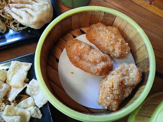 Chicken croquettes with cheese filling inside served in a round bowl made of yellow bamboo