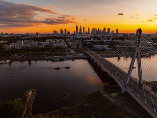 Warsaw city center and skyscrapers in the background Vistula river and Swietokrzyski bridge. Sunset  Warsaw aerial view.