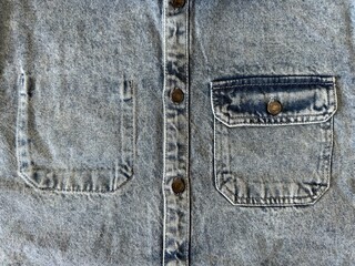 Unique chest pockets on a denim jacket. One pocket is sewn on the outside, the other pocket is sewn on the inside. Outside and inside pocket. Sewing clothes